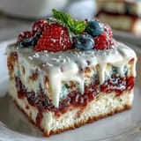 Vibrant Patriotic Poke Cake layered with juicy gelatin and smooth ganache topping.