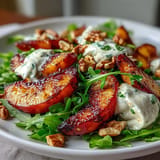 Creamy burrata meets caramelized grilled peaches in this vibrant summer salad.