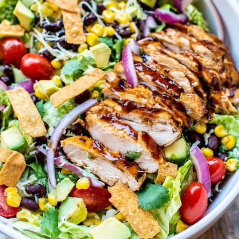 Honey lime chicken taco salad showcases juicy grilled chicken, sweet corn, and black beans tossed in a zesty dressing and topped with crunchy tortilla strips.