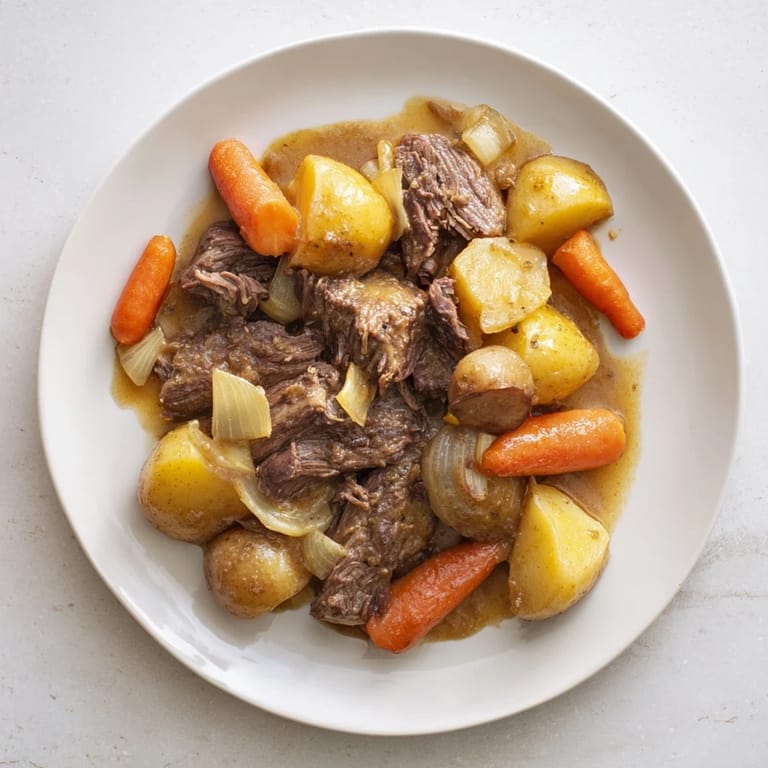 Savory Beef Pot Roast simmering in a Dutch oven, showcasing fall-apart tender meat alongside hearty root vegetables and a glossy, deep brown sauce.
