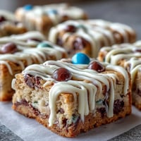 Vibrant Graduation Cookie Bars with white chocolate drizzle and colorful candy toppings, perfect for celebrating academic achievements.